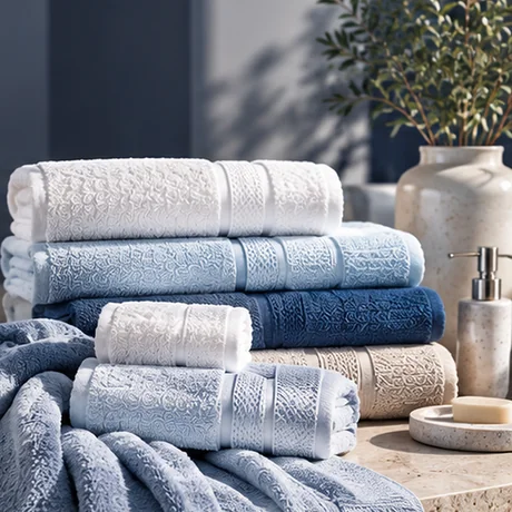 White and blue cotton towels neatly folded in a bathroom setting.
