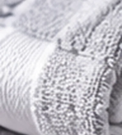 Close-up of a neatly folded white towel hem